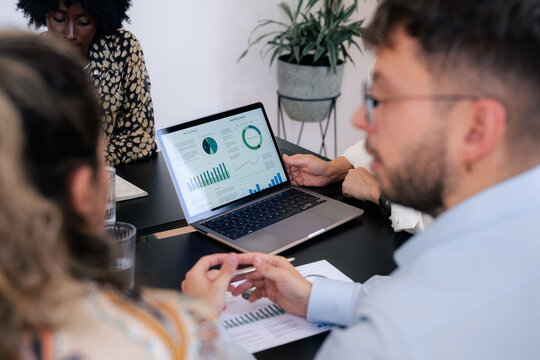 Focused businesspeople reviewing financial report at meeting room 