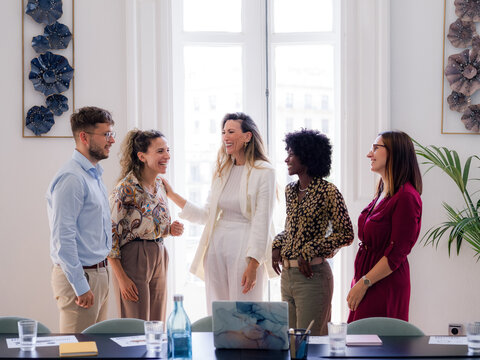 Multiracial group of people talking after business meeting