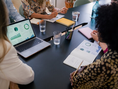 Businesspeople discussing financial data at meeting 