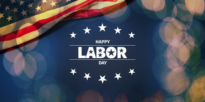 The wrinkled flag of the USA draped onto a flat dark blue surface with a bokeh light overlay and the text "Happy Labor Day"