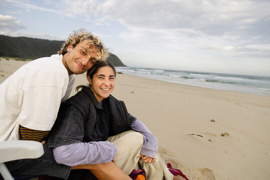 Couple embracing on beach during coastal trip in Crescent Head
