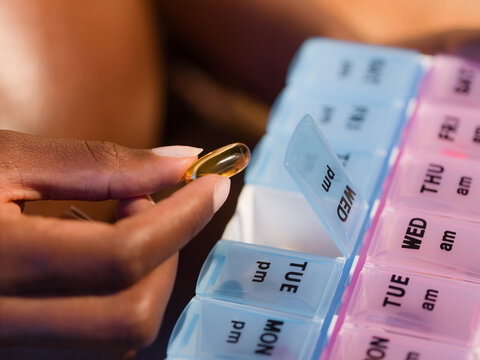 Woman holding omega-3 vitamin 