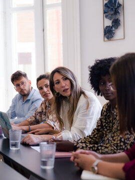 Group of People Discussing Ideas in a Meeting Room During the Day