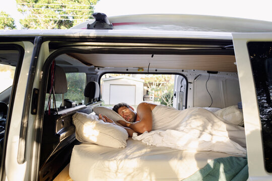 UGC morning scene man sleeping inside campervan