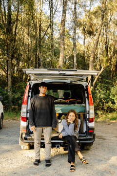 Couple enjoying van life road trip in forest