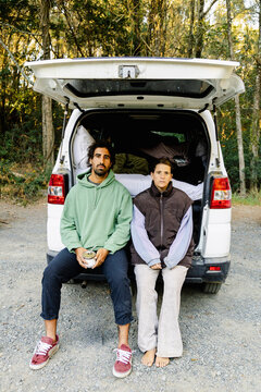 UGC Serious couple posing outside campervan on autumn road trip