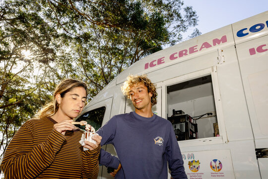 UGC couple sharing ice cream by ice cream truck with direct flash