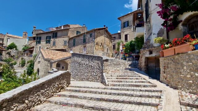 Roccantica Rieti Italy High Resolution. cinematic 4k footage of medieval stone borgo hilltop village alley with ancient stairways and colorful flower pots decoration. Traditional Italian scenery asset