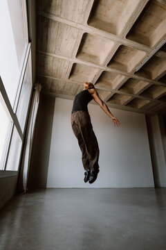 Contemporary dancer jumping in studio