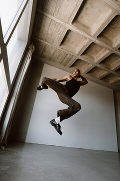 Contemporary dancer jumping in studio