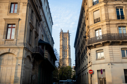 Tour Saint-Jacques framed by historic Paris street buildings