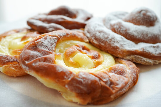 Assorted traditional Mallorcan ensaimada pastries close-up on white background