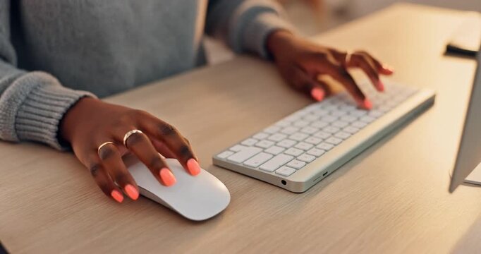 Close up of African American woman hands using computer mouse and keyboard at office desk