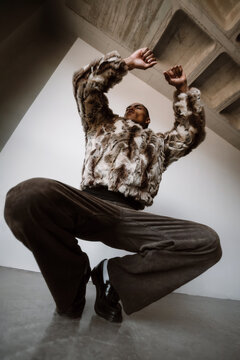 Model Poses in Urban Setting With Unique Outfit and Strong Stance