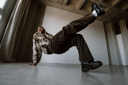 Dancer Performs a Breakdance Move in a Studio During the Day