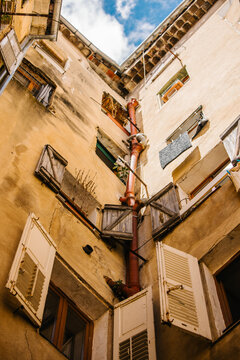 Looking Up at Weathered Mediterranean Courtyard Facade
