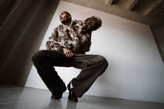 Model Poses in Urban Setting With Unique Outfit and Strong Stance