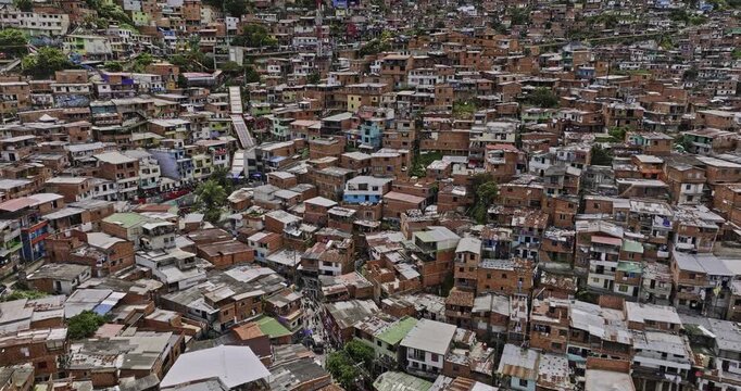 Medellin Colombia Aerial v31 low flyover La Independencia along famous escalators across steep hillside slums Comuna 13 capturing overcrowded decrepit houses - Shot with Mavic 3 Cine - November 2022
