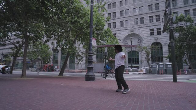 Man Spinning Red Sign On Head - Low Angle In San Francisco