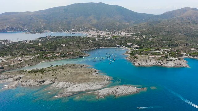 Aerial view of the peaceful Port Lligat Bay, home to Salvador Dal&iacute;'s House Museum, surrounded by crystal-clear Mediterranean waters, rocky shores and the unique landscapes of the Costa Brava. 