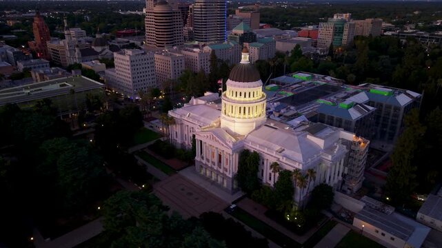 Explore aerial views of California State Capitol in Sacramento at night showing the historic building and ongoing annex construction.
