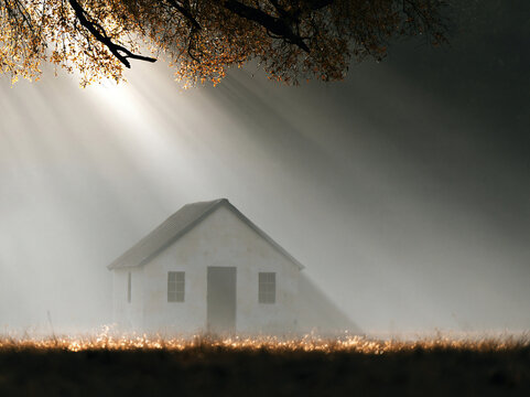Sunbeams Over a Small House in Morning Mist