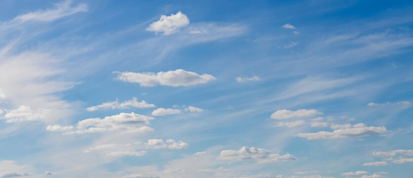 Panoramic blue sky with scattered white clouds on clear day
