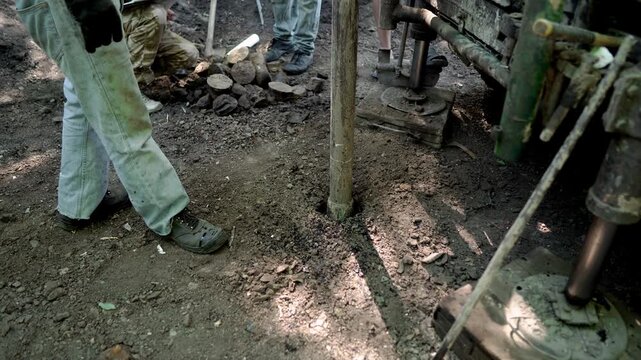 Engineers and drilling specialists operate the drilling equipment while collecting subsurface soil samples for geotechnical analysis, foundation design, and pre-construction site assessment in Ukraine