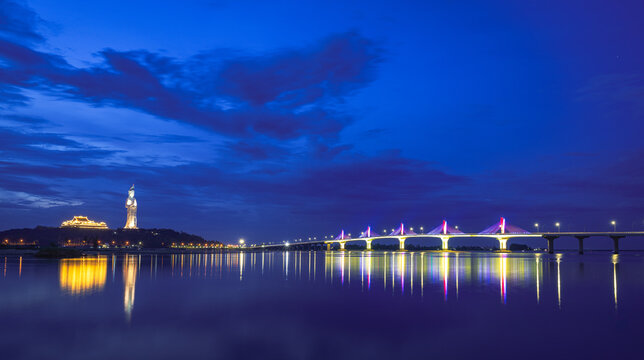 Long exposure dusk photograph of Co Luy Bridge and Chua Minh Duc pagoda together, Quang Ngai Province, Vietnam