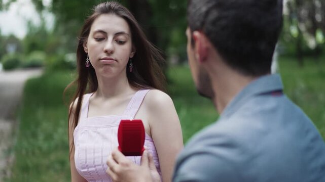 Rejected marriage proposal with man offering ring to an indifferent cold girl