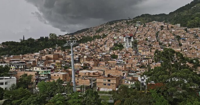 Medellin Colombia Aerial v51 drone flying uphill from El Pinal across 3 de Noviembre, Comuna 8 and Llanaditas along Gondola lift capturing dense hillside homes - Shot with Mavic 3 Cine - November 2022