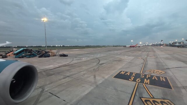 Vietnam Airlines Aircraft Taxiing on Apron at Dusk - Airport Tarmac View from Plane Window