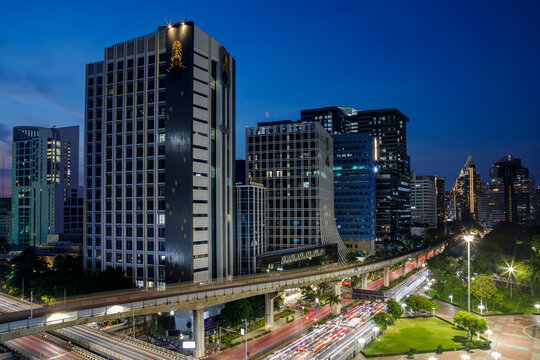 Modern skyscrapers of Bangkok financial district at twilight view from park