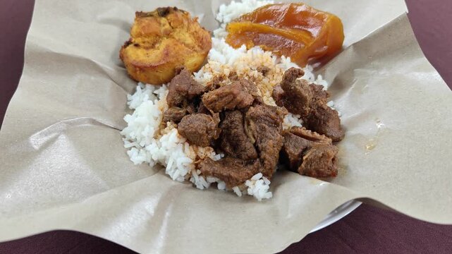 Malaysian Style Rice Pack Packed in Brown Paper with Beef Curry and Fried Egg