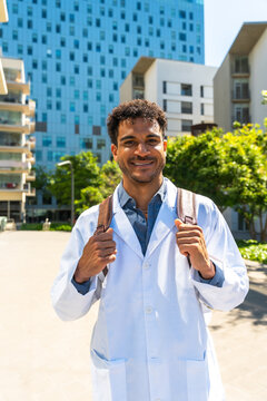Young black student wearing a lab coat and backpack