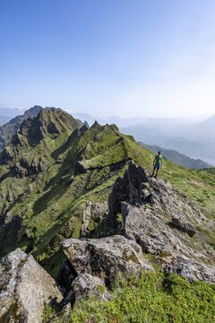Hikers on rocks, Pointed green mountain peaks on the ridge of Tindfj&ouml;ll, overgrown tuff rocks, wild nature, Icelandic Highlands, &THORN;&oacute;rsm&ouml;rk, Su&eth;urland, Iceland