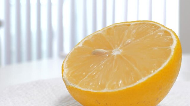 Half of fresh juicy lemon on white kitchen counter