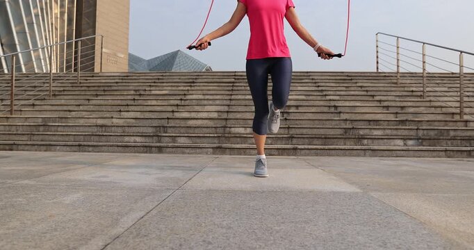 Fitness woman jumping rope in city