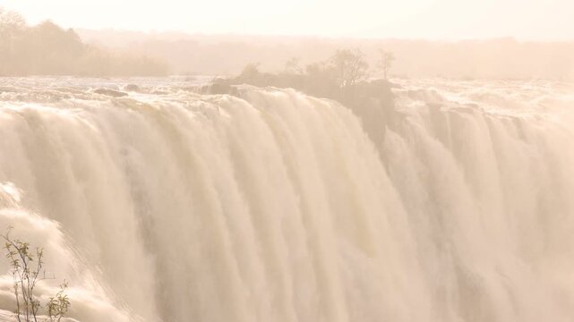The Zambezi River from the Zambian side, rushing toward the edge of Victoria Falls, Zambia, Africa