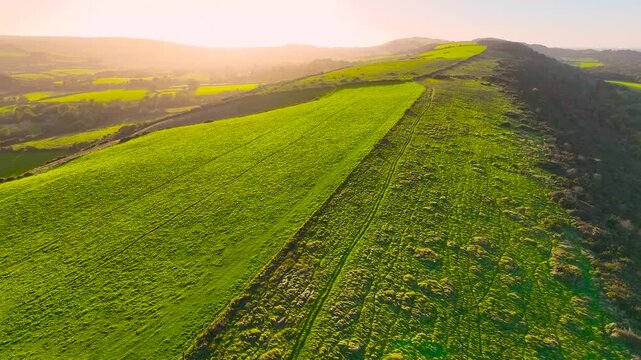 Aerial sunset view of Corfe Castle, a village and civil parish in the English county of Dorset, UK