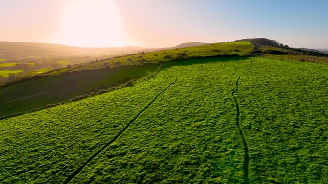 Aerial sunset view of Corfe Castle, a village and civil parish in the English county of Dorset, UK