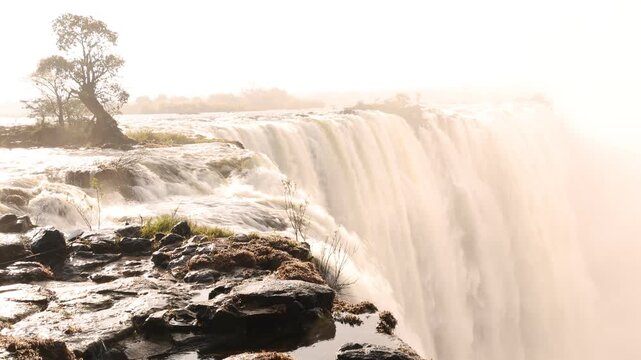 The Zambezi River from the Zambian side, rushing toward the edge of Victoria Falls, Zambia, Africa