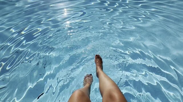 Relaxing summer swim with feet in cool water
