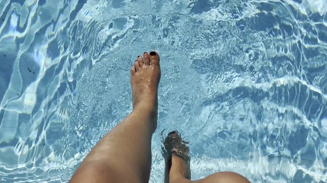 Feet enjoying a cool swim in the refreshing pool water