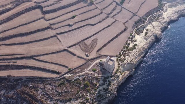 Mgarr ix-Xini Tower, Aerial view, with Heart on the agricultural field nearby. Gozo, Malta. High quality 4k footage