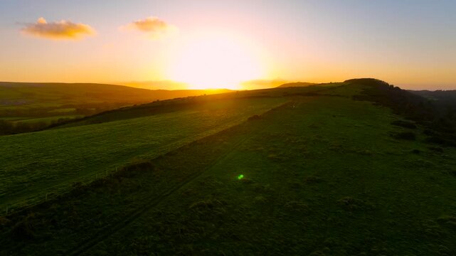 Aerial sunset view of Corfe Castle, a village and civil parish in the English county of Dorset, UK