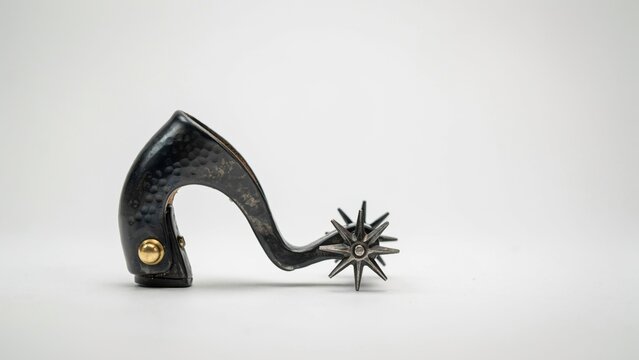 Vintage metal cowboy spur isolated on white background