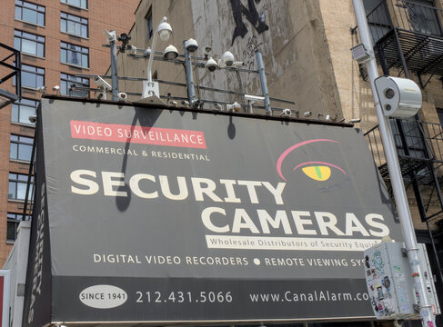 many security cameras mounted above building monitoring secure area cctv closed circuit television monitor surveillance state paranoia paranoid camera government watching usa america new york city