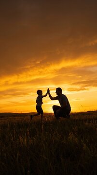 Father giving son high five. Parent child relationship concept