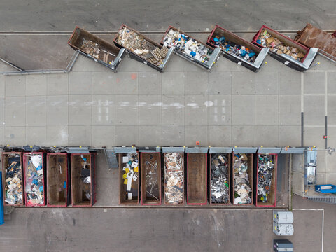Aerial view of municipal Beverwijk recycling center with various waste containers arranged in rows at a waste collection facility in Beverwijk, Noord-Holland, Netherlands.